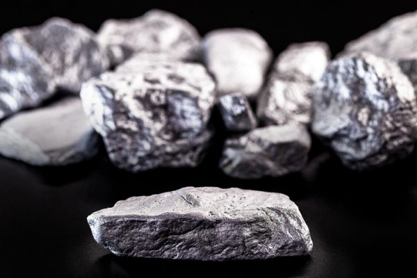 Manganese, manganese or magnesium stone is a chemical element, it is in the manufacture of metal alloys. Silver colored ore, industrial use. Ore on black isolated background.